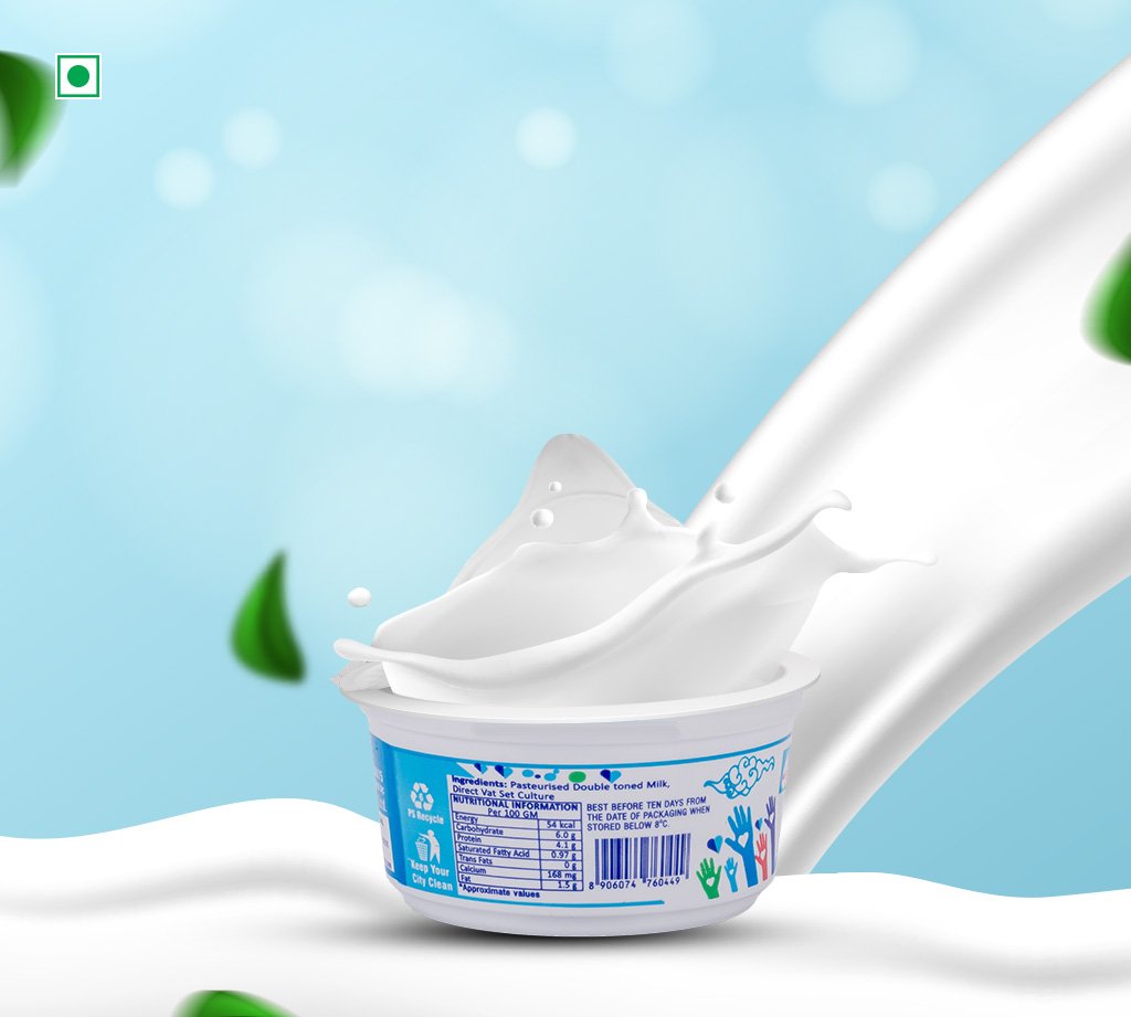 Yogurt cup with white milk splash arcing above on a snowy backdrop.