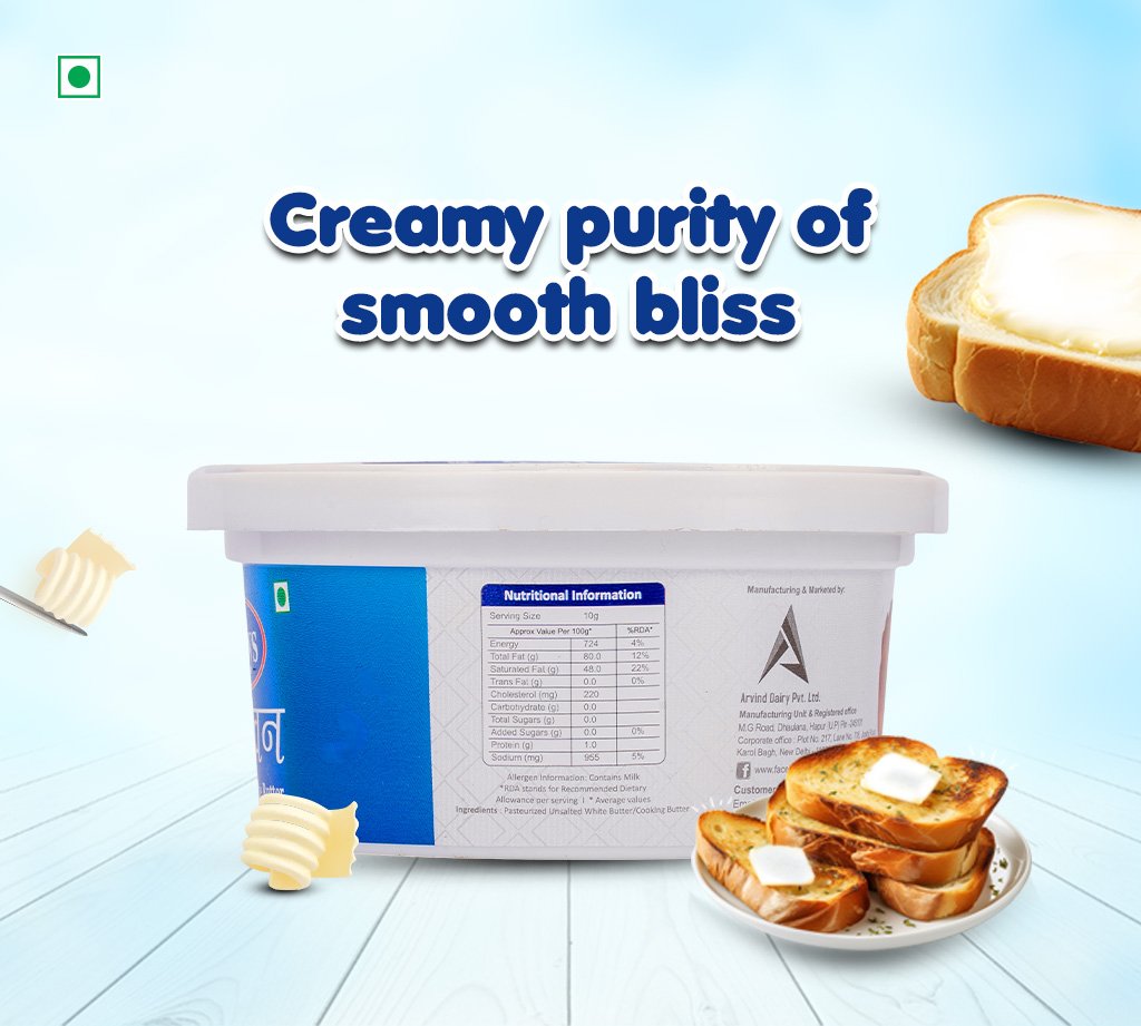 Tub of butter with butter curls, toast on a plate, and a bold slogan reading 'Creamy purity of smooth bliss' against a pale blue backdrop.