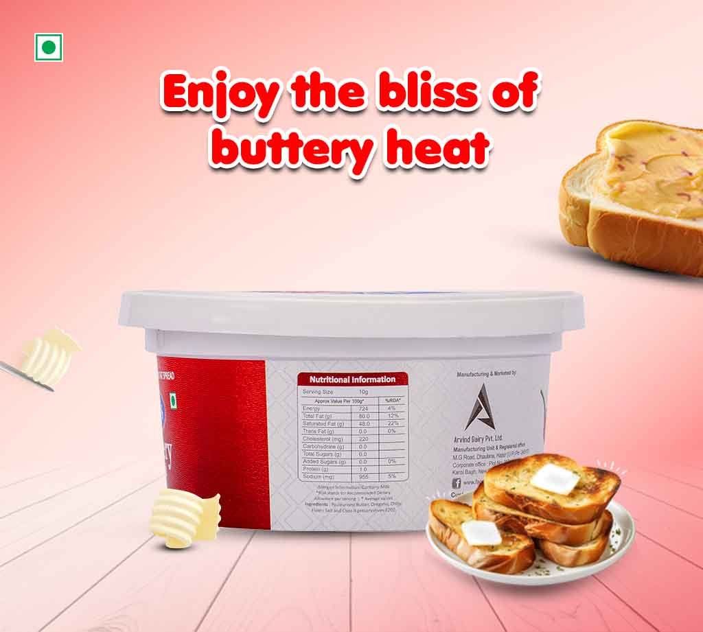 Advertisement image promoting butter spread with a tub of butter, toast with butter, and pats of butter on a pink gradient background.