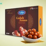 Boxed Arlys Gulab Jamun traditional sweets with a bowl of gulab jamun in front on a light background