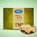 Arlys Pista Burfi box with traditional sweets design, pistachio fudge pieces displayed on a decorative plate in front.