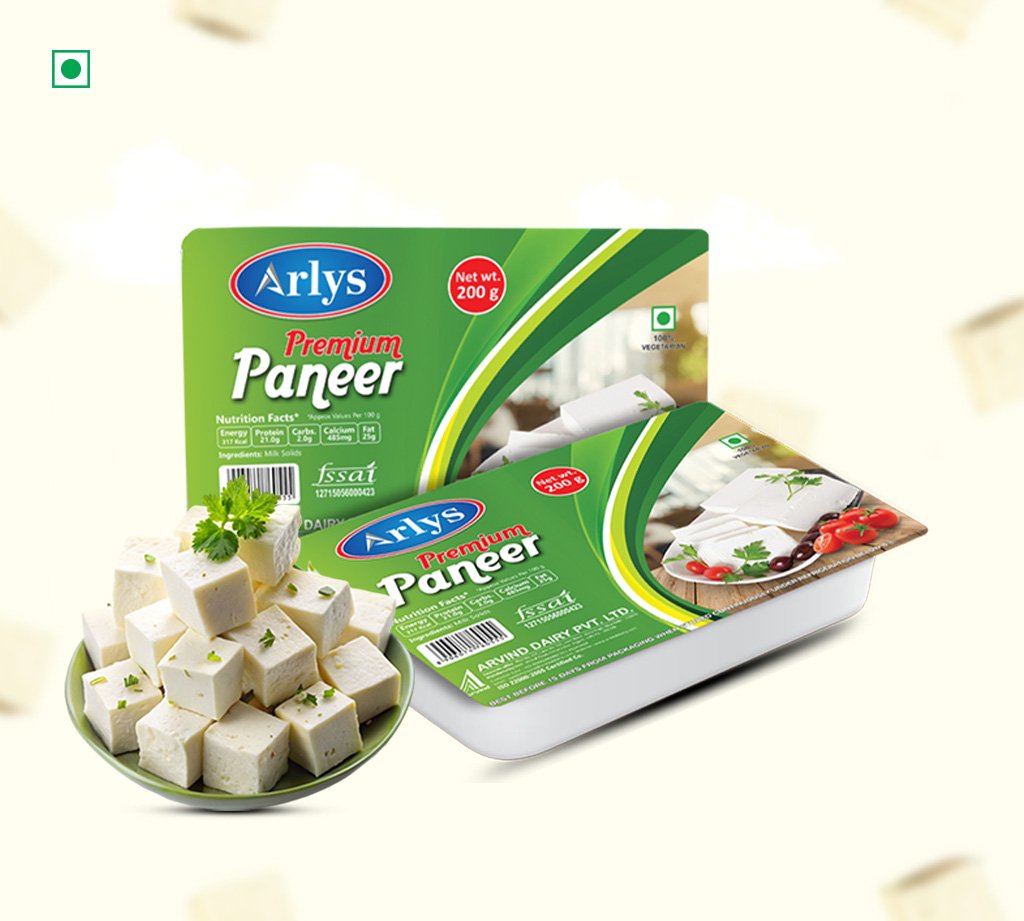 Green packaging of Arlys Premium Paneer with a bowl of cubed paneer in the foreground.