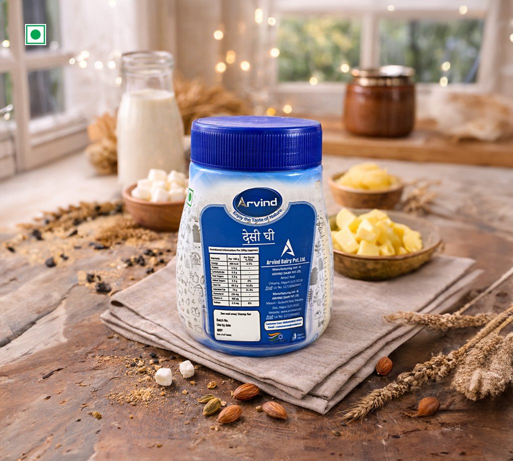 Blue container of Arvind milk powder on a wooden table with dairy ingredients in a cozy kitchen setting.